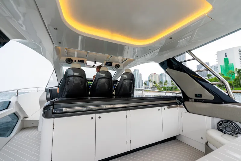 Slide: The Image of 2021 Azimut Verve 47 yacht interior with modern seating and city skyline view. - 8