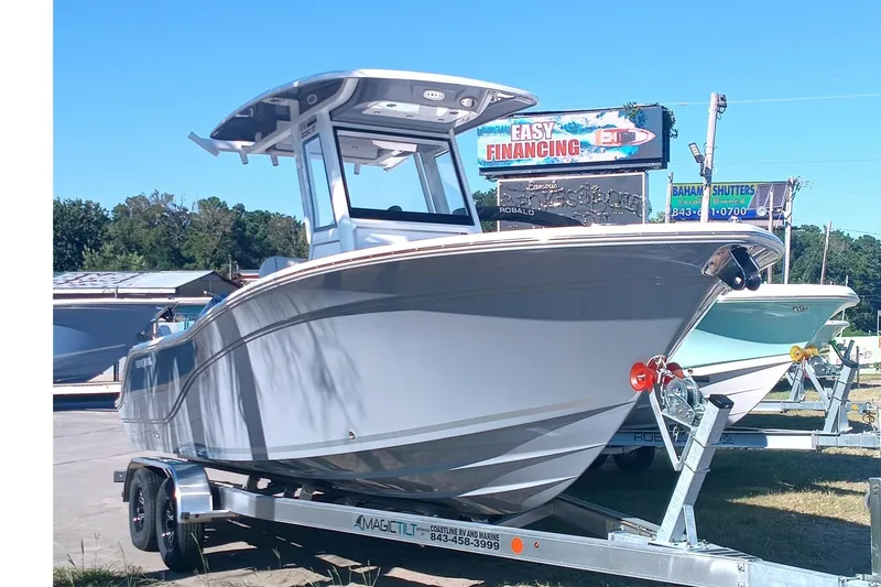 The Image of 2025 Seafox 228 Commander boat on trailer under clear blue sky. - 0