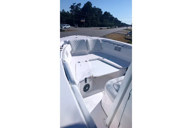 Slide: The Image of 2025 Seafox 228 Commander boat interior with white seating and spacious deck. - 3