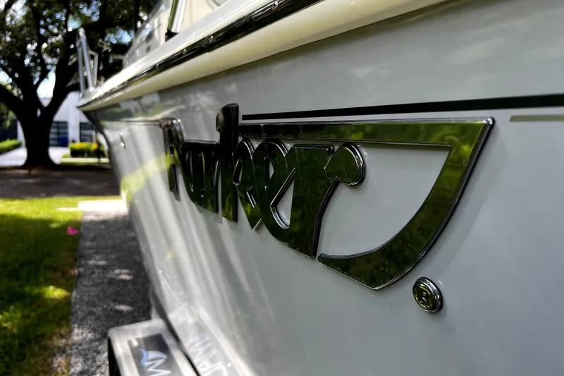Slide: The Image of 2023 Parker 2120 Sport Cabin boat with chrome logo detail. - 11