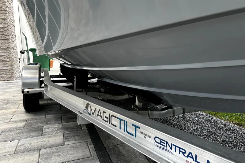 Slide: The Image of 2023 Parker 2120 Sport Cabin boat on Magic Tilt trailer, side view. - 17
