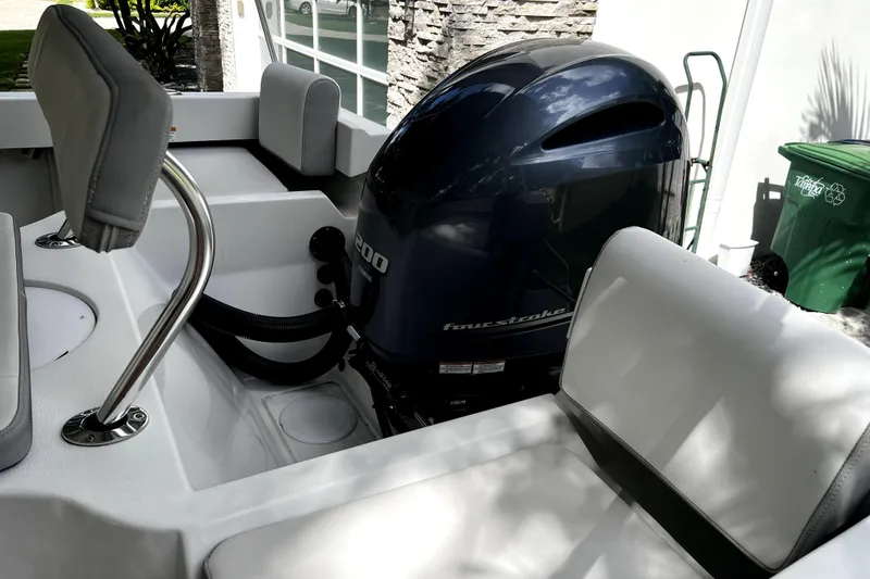 Slide: The Image of 2023 Parker 2120 Sport Cabin boat with a powerful four-stroke engine. - 26