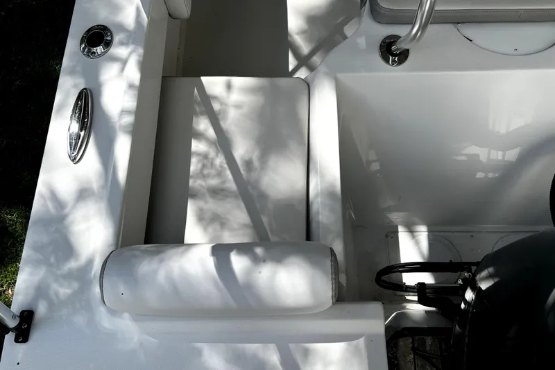 Slide: The Image of 2023 Parker 2120 Sport Cabin interior with shadows on white seating and chrome details. - 27