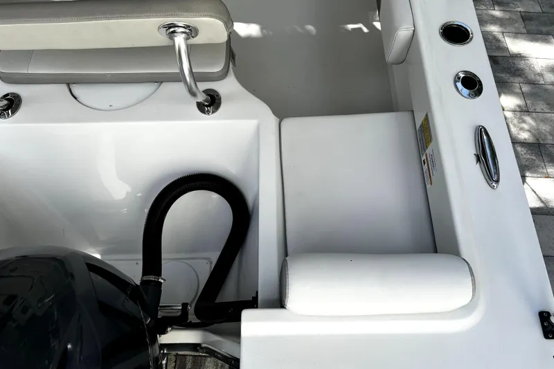 Slide: The Image of 2023 Parker 2120 Sport Cabin boat interior with seating and engine compartment. - 28