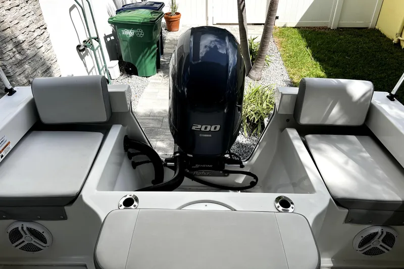 Slide: The Image of 2023 Parker 2120 Sport Cabin boat with Yamaha 200 engine, outdoor setting. - 29