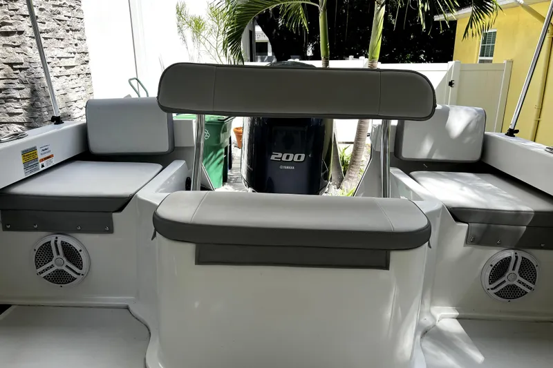 Slide: The Image of 2023 Parker 2120 Sport Cabin boat interior with seating and Yamaha 200 engine. - 30