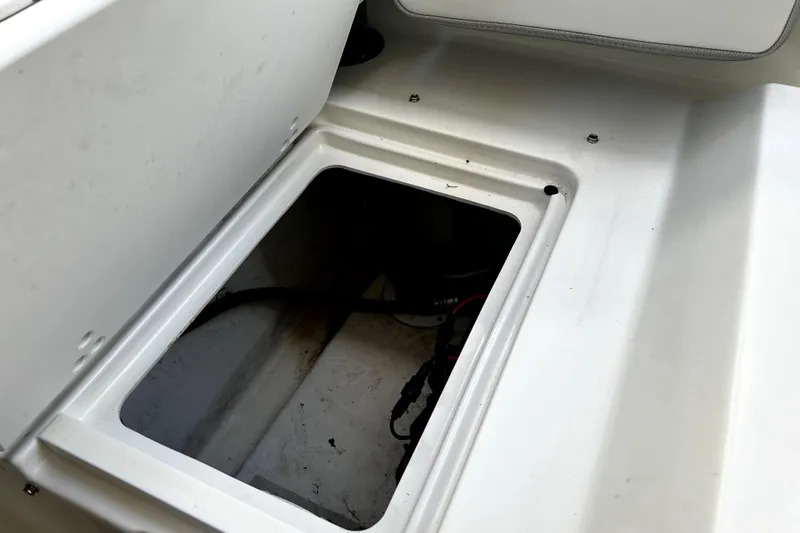 Slide: The Image of Open storage compartment in 2023 Parker 2120 Sport Cabin boat interior. - 37