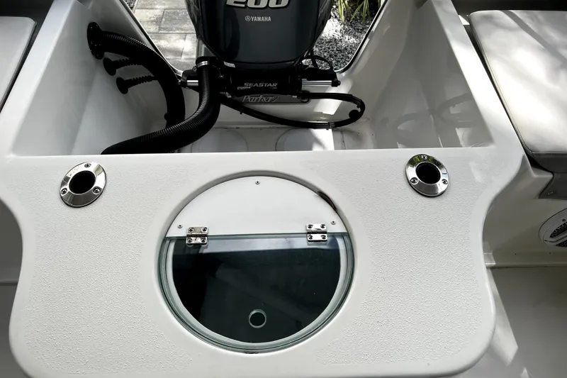 Slide: The Image of 2023 Parker 2120 Sport Cabin boat with Yamaha 200 engine, featuring a circular hatch. - 39