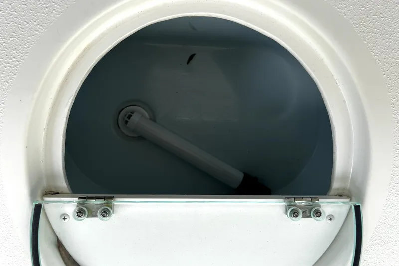 Slide: The Image of Parker 2120 Sport Cabin 2023 boat compartment with open hatch and visible interior. - 40