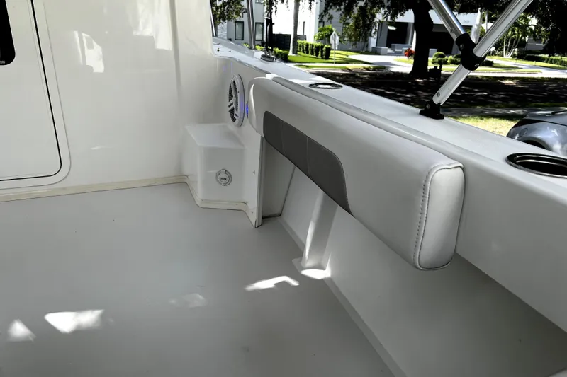 Slide: The Image of 2023 Parker 2120 Sport Cabin interior with cushioned seating and cup holders. - 43