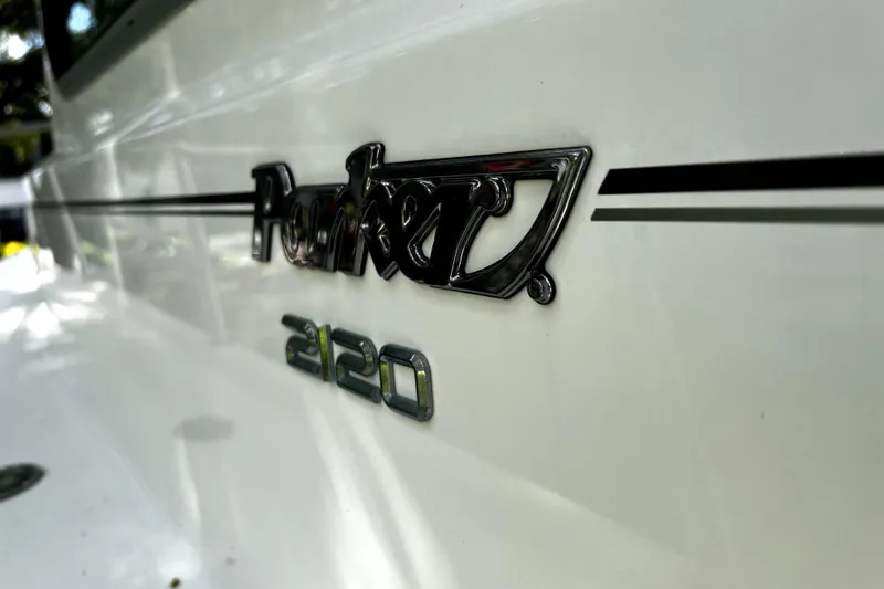 Slide: The Image of 2023 Parker 2120 Sport Cabin boat logo on white surface. - 46