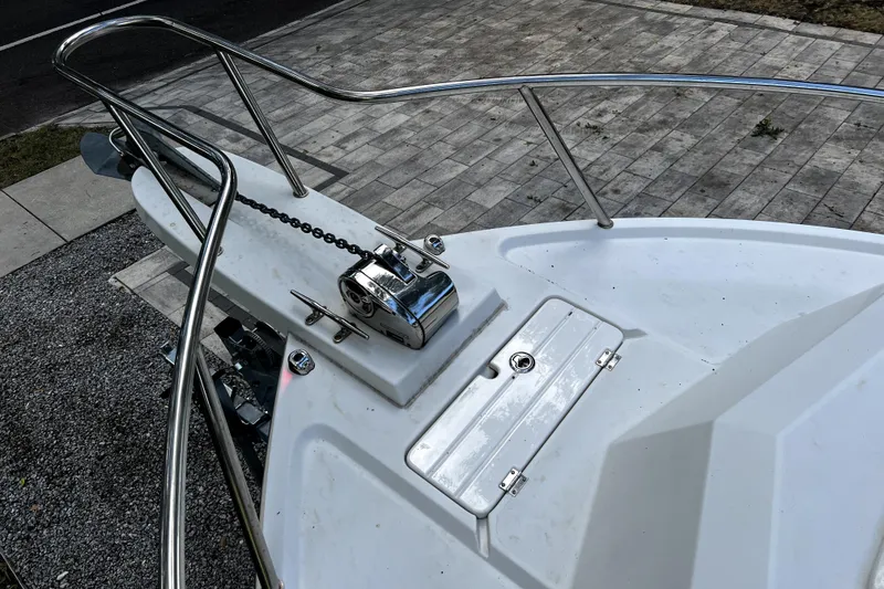 Slide: The Image of 2023 Parker 2120 Sport Cabin boat deck with anchor chain and winch. - 50