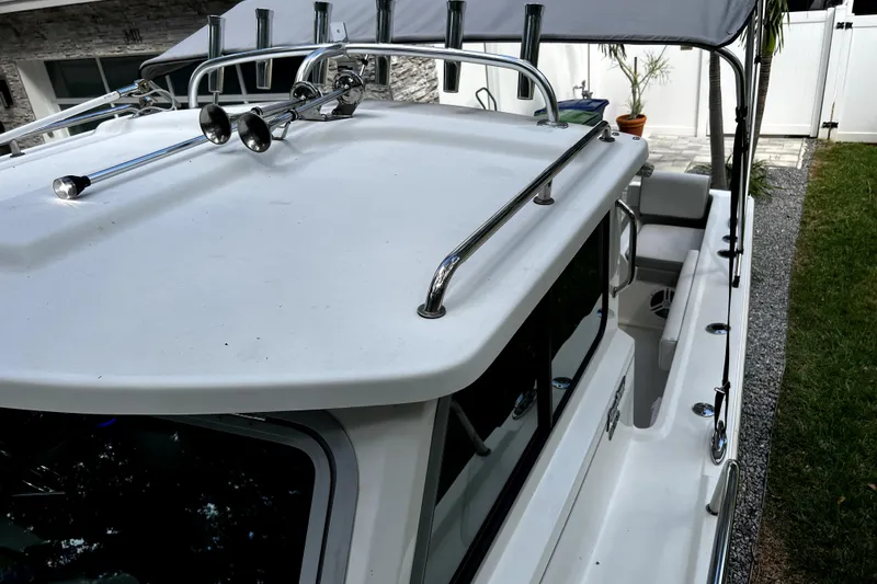 Slide: The Image of 2023 Parker 2120 Sport Cabin boat with sleek design and chrome details. - 52