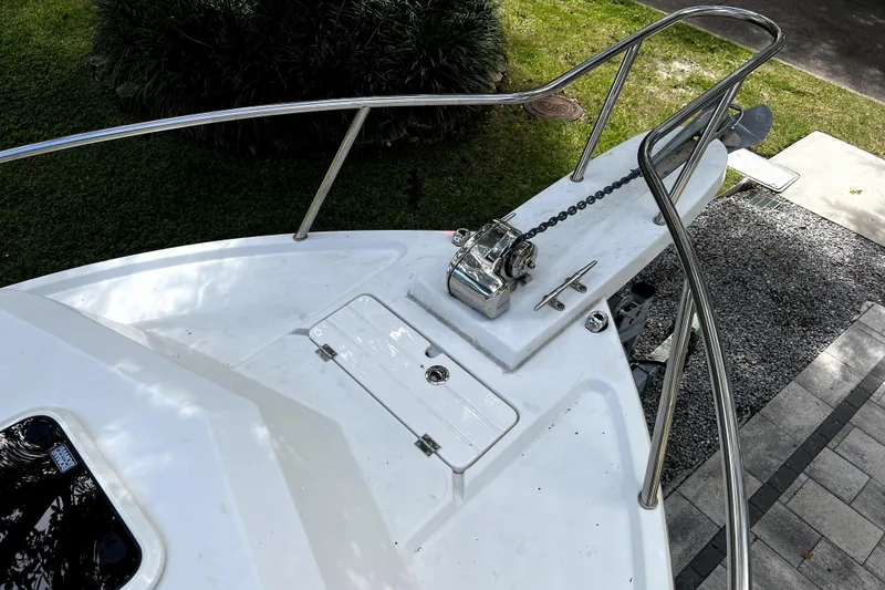 Slide: The Image of 2023 Parker 2120 Sport Cabin boat deck with anchor chain and railing. - 57