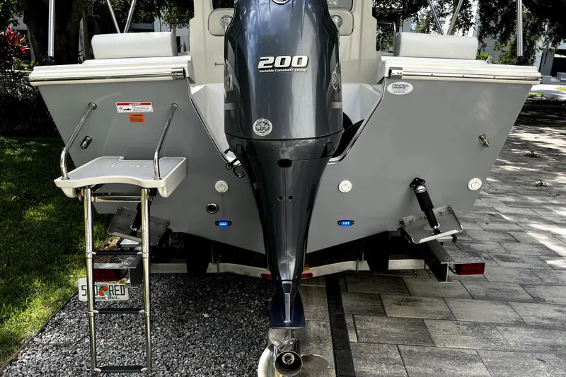 Slide: The Image of 2023 Parker 2120 Sport Cabin boat with Yamaha 200 outboard motor, rear view. - 6