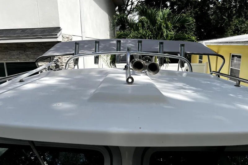 Slide: The Image of 2023 Parker 2120 Sport Cabin boat roof with rod holders and horns. - 60
