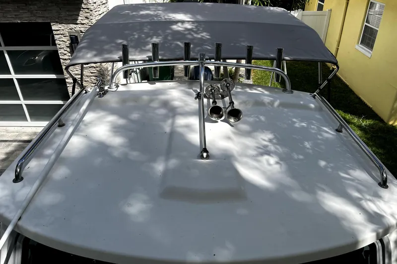 Slide: The Image of 2023 Parker 2120 Sport Cabin boat with canopy and railings, viewed from above. - 61