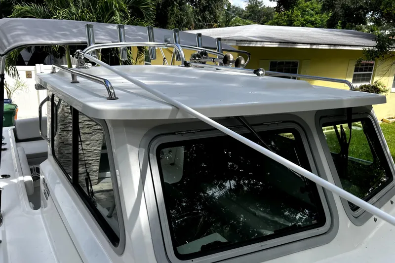Slide: The Image of 2023 Parker 2120 Sport Cabin boat with sleek design and sturdy roof rails. - 63