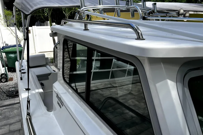 Slide: The Image of 2023 Parker 2120 Sport Cabin boat with sleek design and chrome railings. - 66