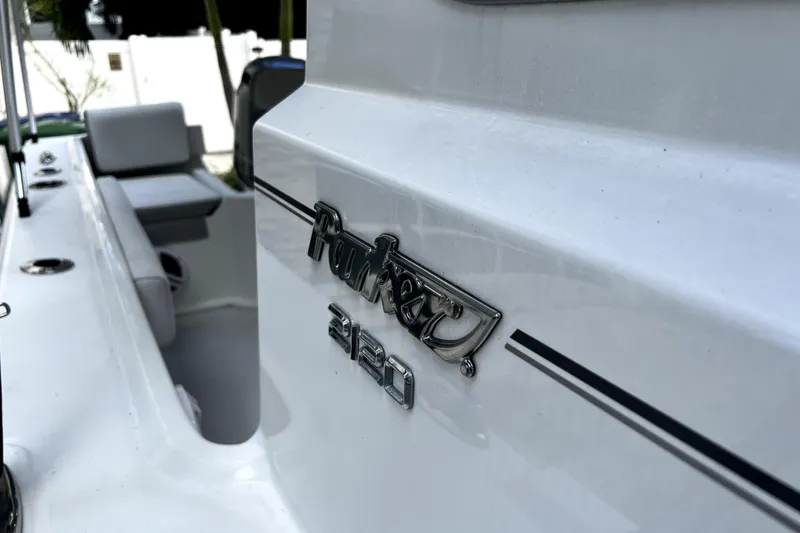 Slide: The Image of 2023 Parker 2120 Sport Cabin boat, close-up of logo and seating area. - 67