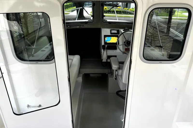 Slide: The Image of 2023 Parker 2120 Sport Cabin interior with steering wheel and navigation display. - 68
