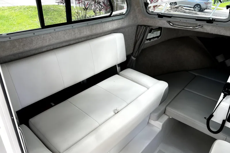 Slide: The Image of Interior of 2023 Parker 2120 Sport Cabin with white seating and windows. - 70