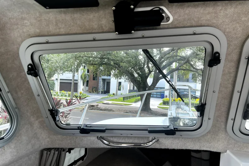 Slide: The Image of Interior view from a 2023 Parker 2120 Sport Cabin boat window, showing a scenic street. - 72