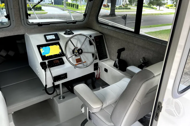 Slide: The Image of 2023 Parker 2120 Sport Cabin interior with steering wheel and navigation system. - 75