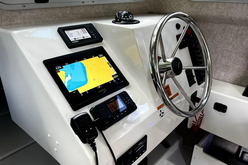 Slide: The Image of 2023 Parker 2120 Sport Cabin dashboard with navigation and control systems. - 76
