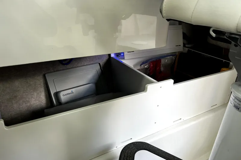 Slide: The Image of Interior storage compartment of 2023 Parker 2120 Sport Cabin boat with Garmin equipment. - 79