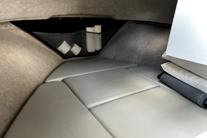 Slide: The Image of 2023 Parker 2120 Sport Cabin interior with cushioned seating and storage net. - 83