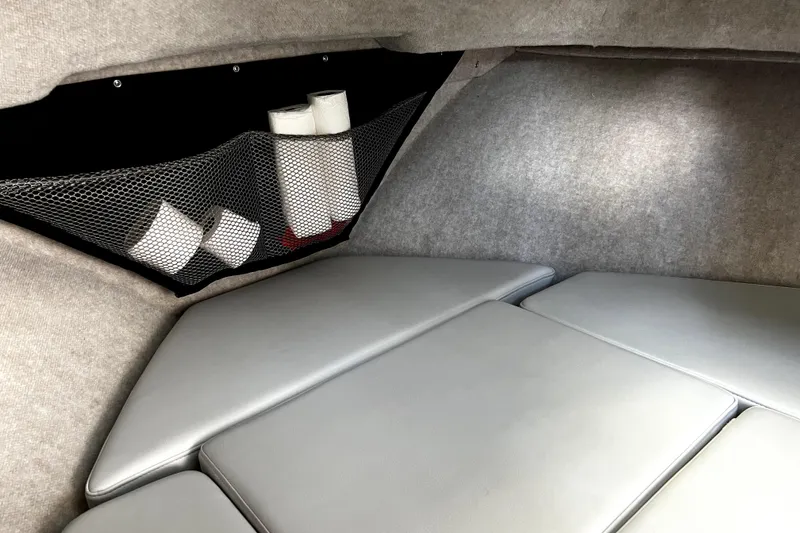 Slide: The Image of 2023 Parker 2120 Sport Cabin interior with cushioned seating and storage net. - 84