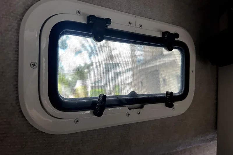Slide: The Image of Porthole window in 2023 Parker 2120 Sport Cabin boat interior. - 86