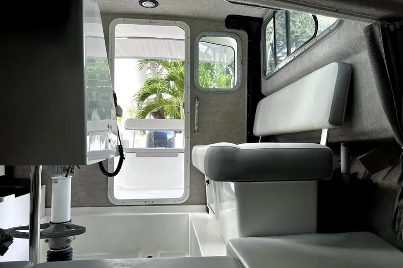 Slide: The Image of Interior of 2023 Parker 2120 Sport Cabin boat with seating and door view. - 91