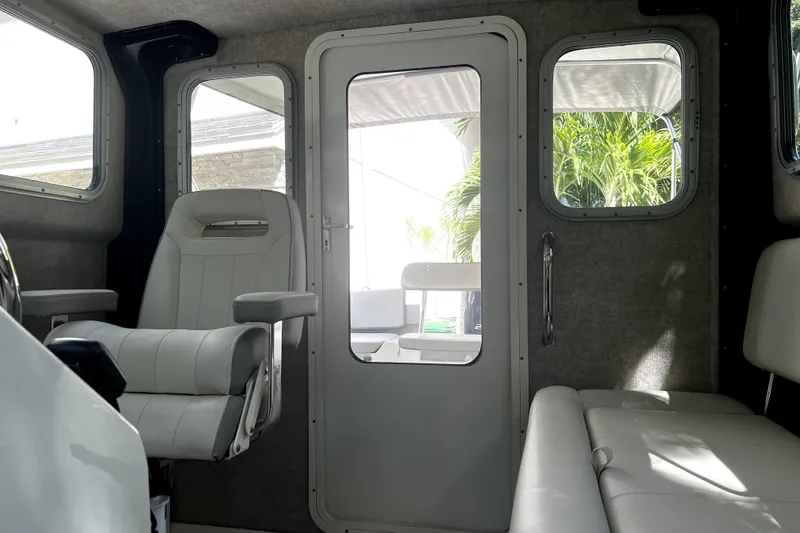Slide: The Image of Interior of 2023 Parker 2120 Sport Cabin with seating and windows. - 92