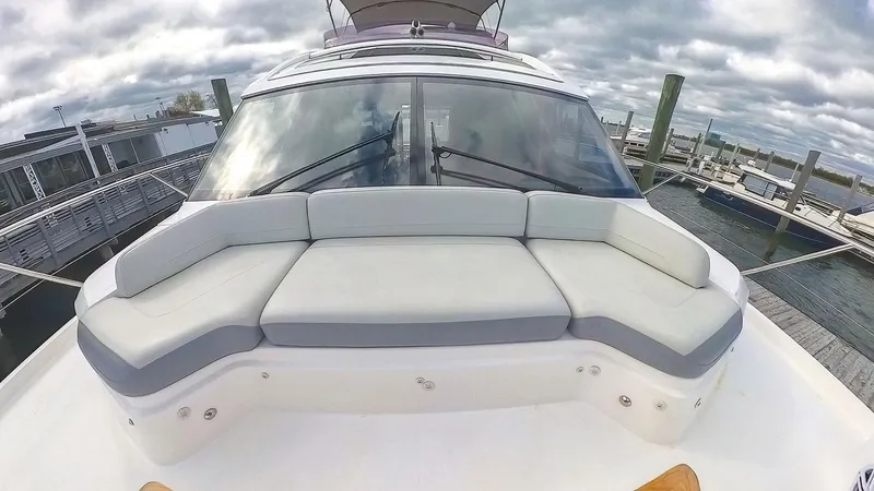 Slide: The Image of 2018 Princess S60 yacht with spacious deck seating under cloudy skies. - 13