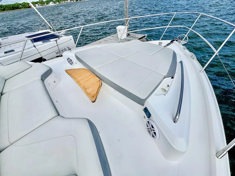 Slide: The Image of 2018 Princess S60 yacht deck with cushioned seating and ocean view. - 15
