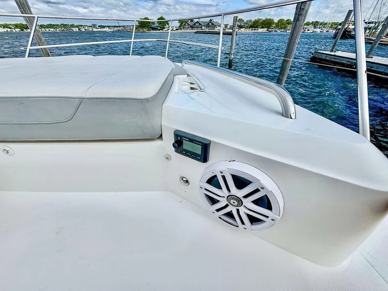 Slide: The Image of Luxury 2018 Princess S60 yacht deck with speaker, overlooking serene marina waters. - 16