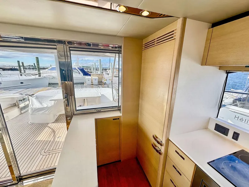 Slide: The Image of Interior view of 2018 Princess S60 yacht kitchen with modern design and marina backdrop. - 32