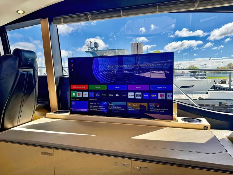 Slide: The Image of Luxurious 2018 Princess S60 yacht interior with modern entertainment system and scenic marina view. - 38