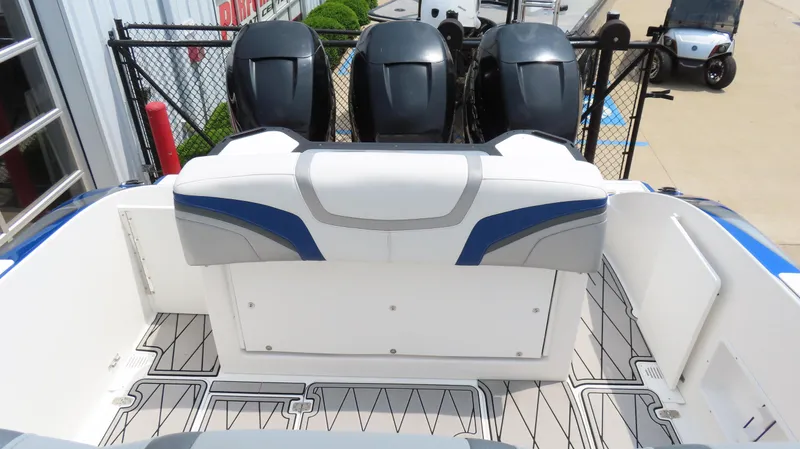 Slide: The Image of 2015 Sunsation 34 CCX boat with triple outboard motors and spacious seating area. - 16