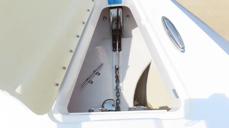 Slide: The Image of Anchor compartment of 2015 Sunsation 34 CCX boat, showcasing chain and cleat. - 21