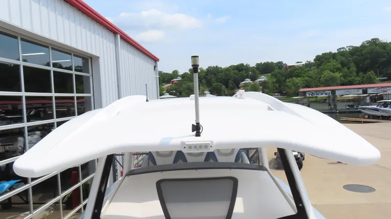 Slide: The Image of 2015 Sunsation 34 CCX boat with sleek white roof, docked near a marina. - 26