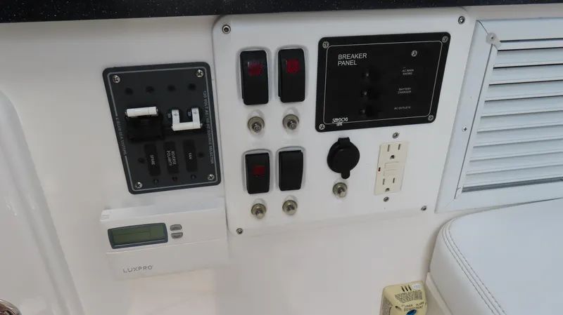 Slide: The Image of Control panel of a 2015 Sunsation 34 CCX boat with switches and outlets. - 30