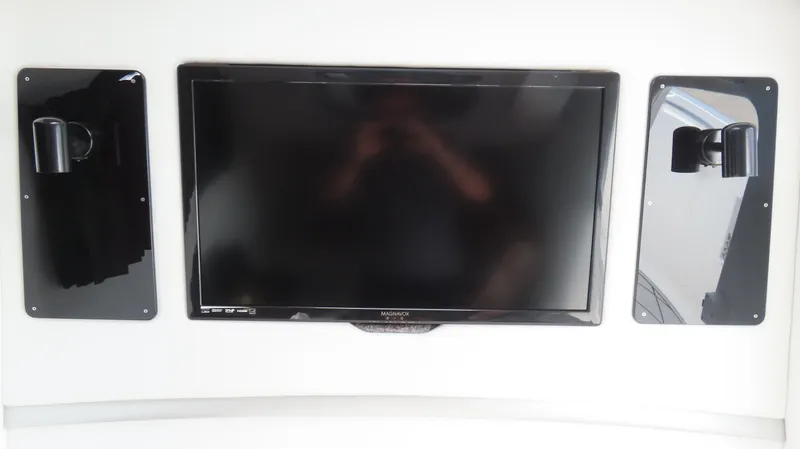 Slide: The Image of 2015 Sunsation 34 CCX interior with mounted flat-screen TV and speakers. - 31
