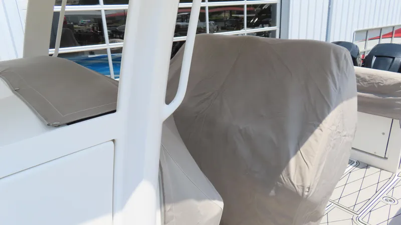 Slide: The Image of 2015 Sunsation 34 CCX boat with protective cover, docked near a building. - 5