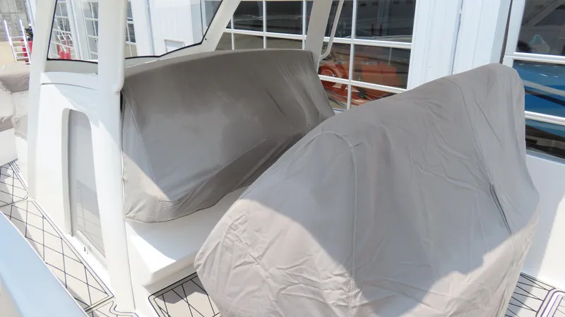 Slide: The Image of 2015 Sunsation 34 CCX boat with covered seating area, docked near a building. - 7