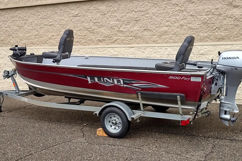 Slide: The Image of 2015 Lund 1600 Fury Tiller boat with Honda motor on trailer. - 1