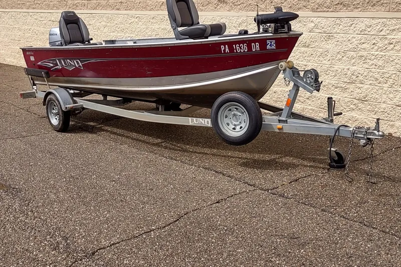 Slide: The Image of 2015 Lund 1600 Fury Tiller boat on trailer, parked outdoors. - 4