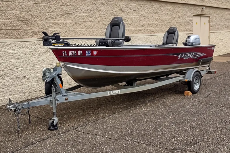 Slide: The Image of 2015 Lund 1600 Fury Tiller boat on trailer, parked outdoors. - 5